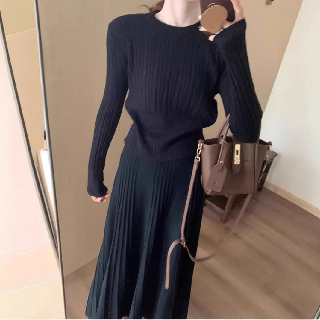 Dark grey knitted dress suit set with 3D pattern, featuring a sweater and skirt.