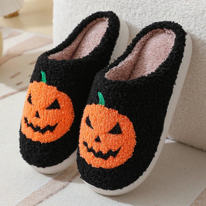 Cozy Halloween-themed pumpkin slippers in white and black colors, featuring soft suede uppers and durable rubber soles for indoor wear