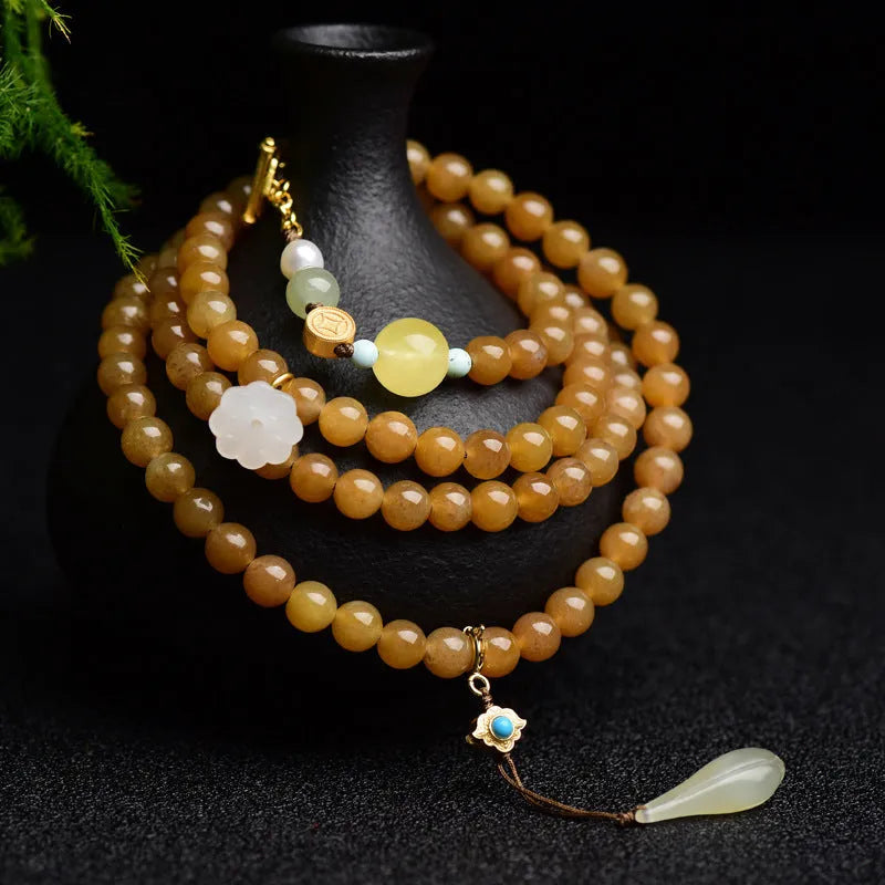 Green jade bead bracelet with leaf shapes and sequins on wrist