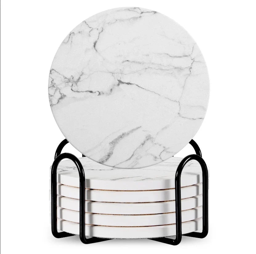 Set of 6 round ceramic coasters with metal stands and cork bases on a wooden table