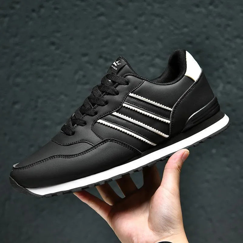 Men's black space leather running shoes with carved wing pattern and mesh lining