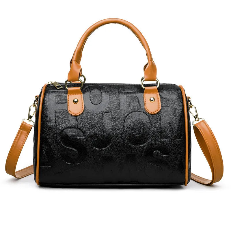 Cylindrical brown PU leather crossbody bag with three shoulder straps displayed