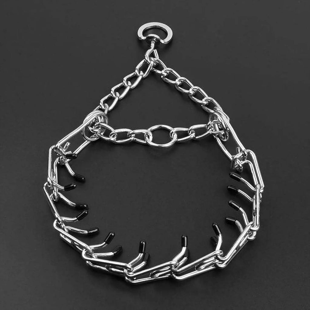 Stainless steel dog prong training collar with rubber tips and adjustable chain links on a grey background.