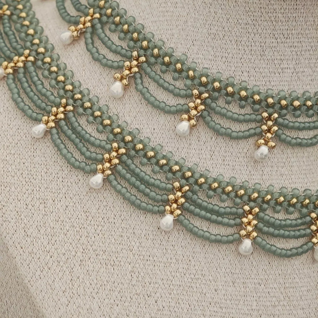 Retro style tassel water drop imitation pearl pendant necklace on display