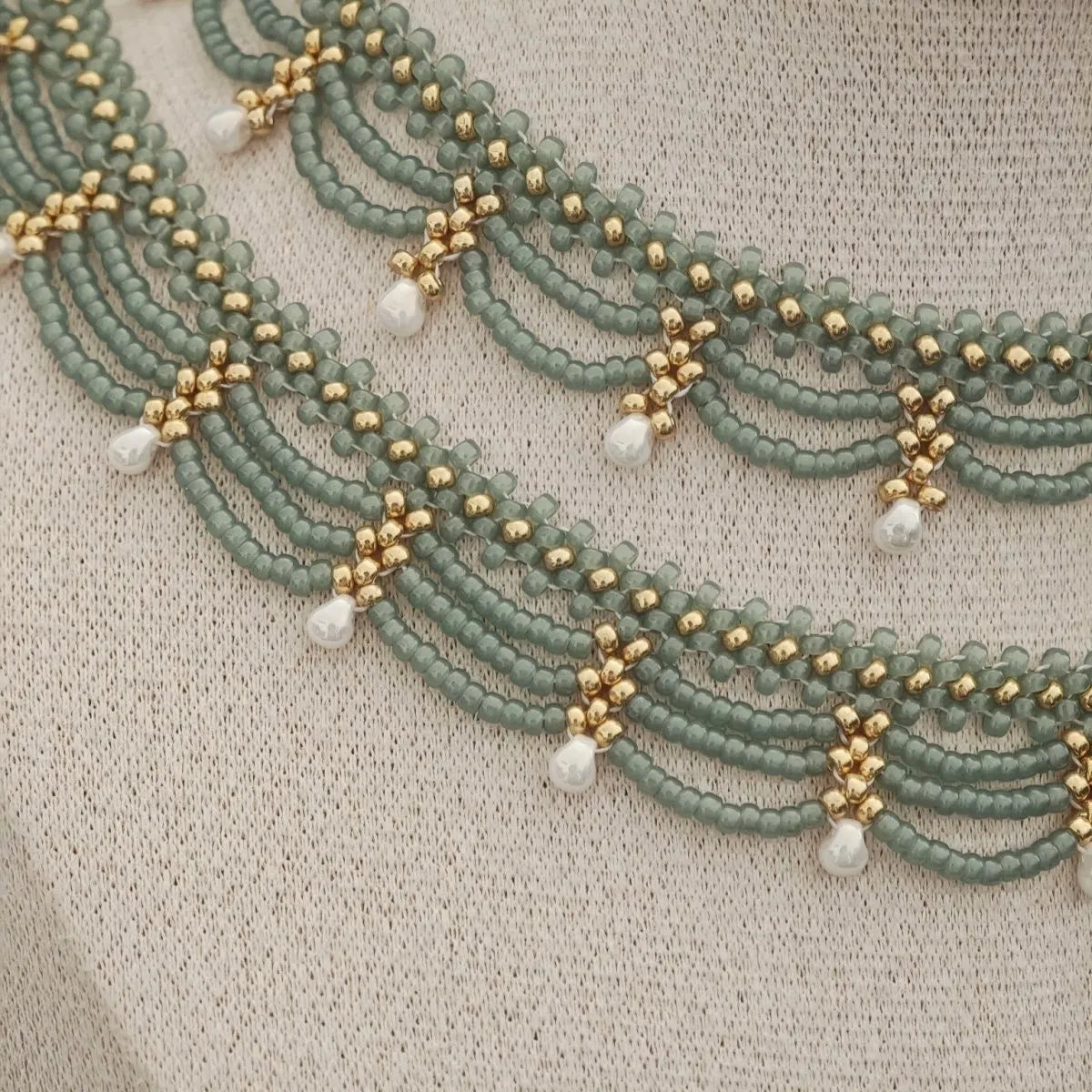 Retro style tassel water drop imitation pearl pendant necklace on display