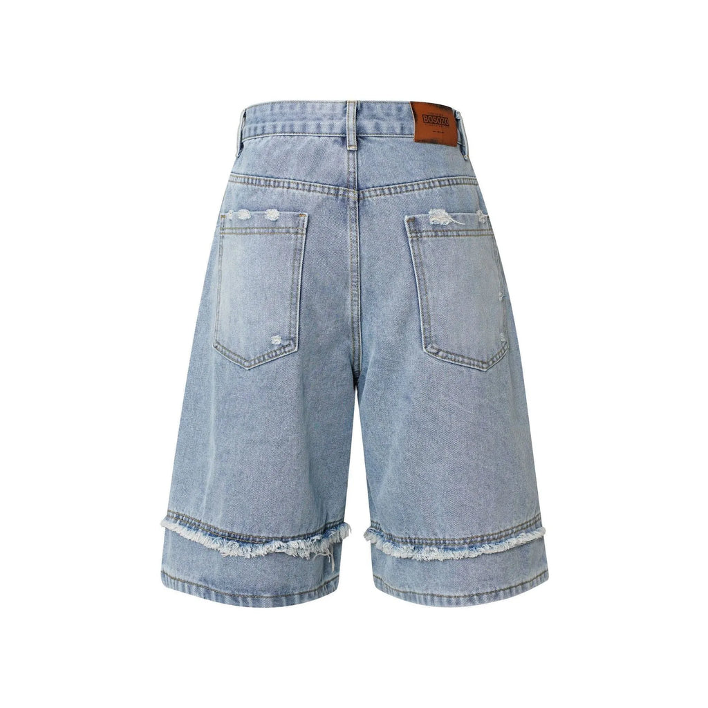 Distressed denim shorts with raw edge detailing in straight leg cropped cut
