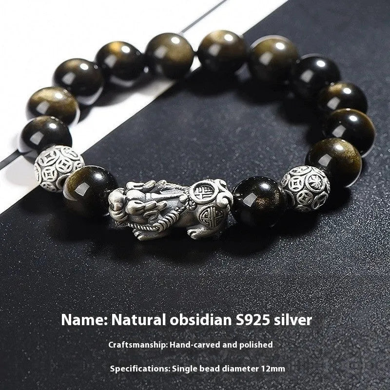 Men's geometric bracelet made of black obsidian and polished 999 sterling silver, showing its width and structured design.