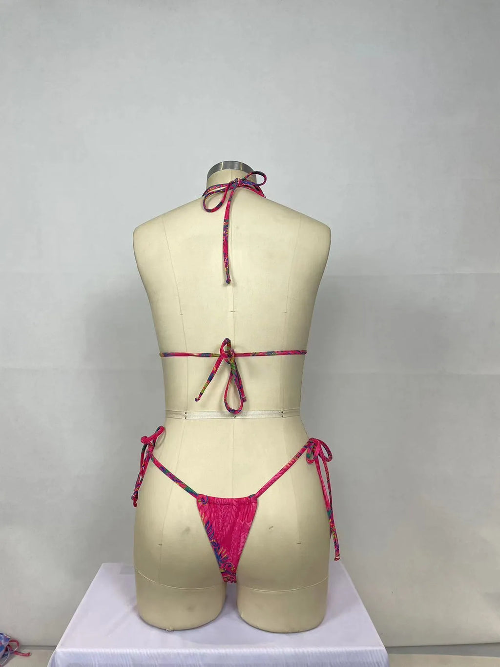 Pink printed women's bikini two-piece set with sleeveless backless design