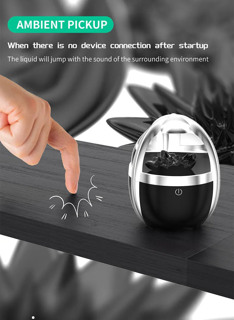Magnetic fluid Bluetooth speaker in Silver Black with solid wood bracket on a table