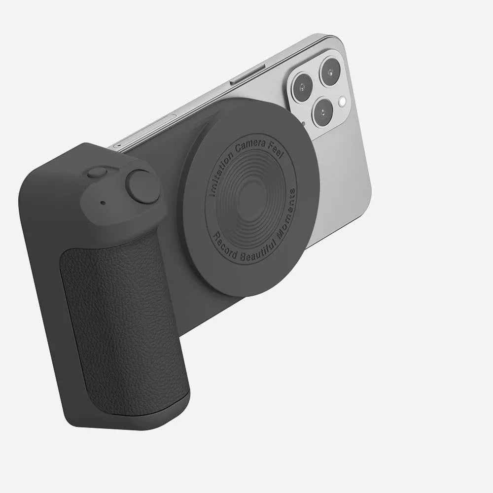 Black magnetic 3-in-1 phone camera grip and stand with ergonomic handle on a table