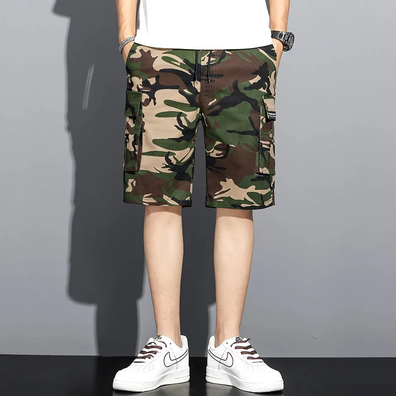Men's camouflage 5-point workwear shorts in green, front view, with drawstring waist and mid-thigh length