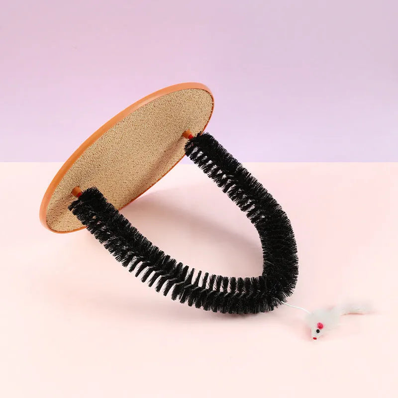 Black arch-shaped cat grooming brush with attached plush mouse toy on non-slip scratching base