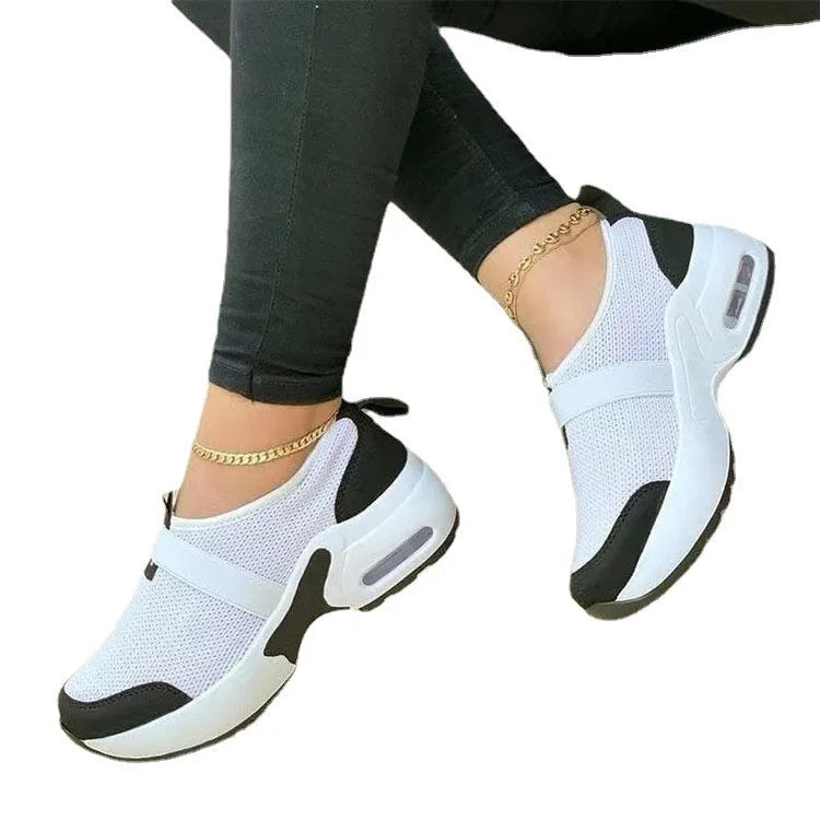 Women's flat lightweight sneakers in multiple colours with mesh upper and rubber sole.