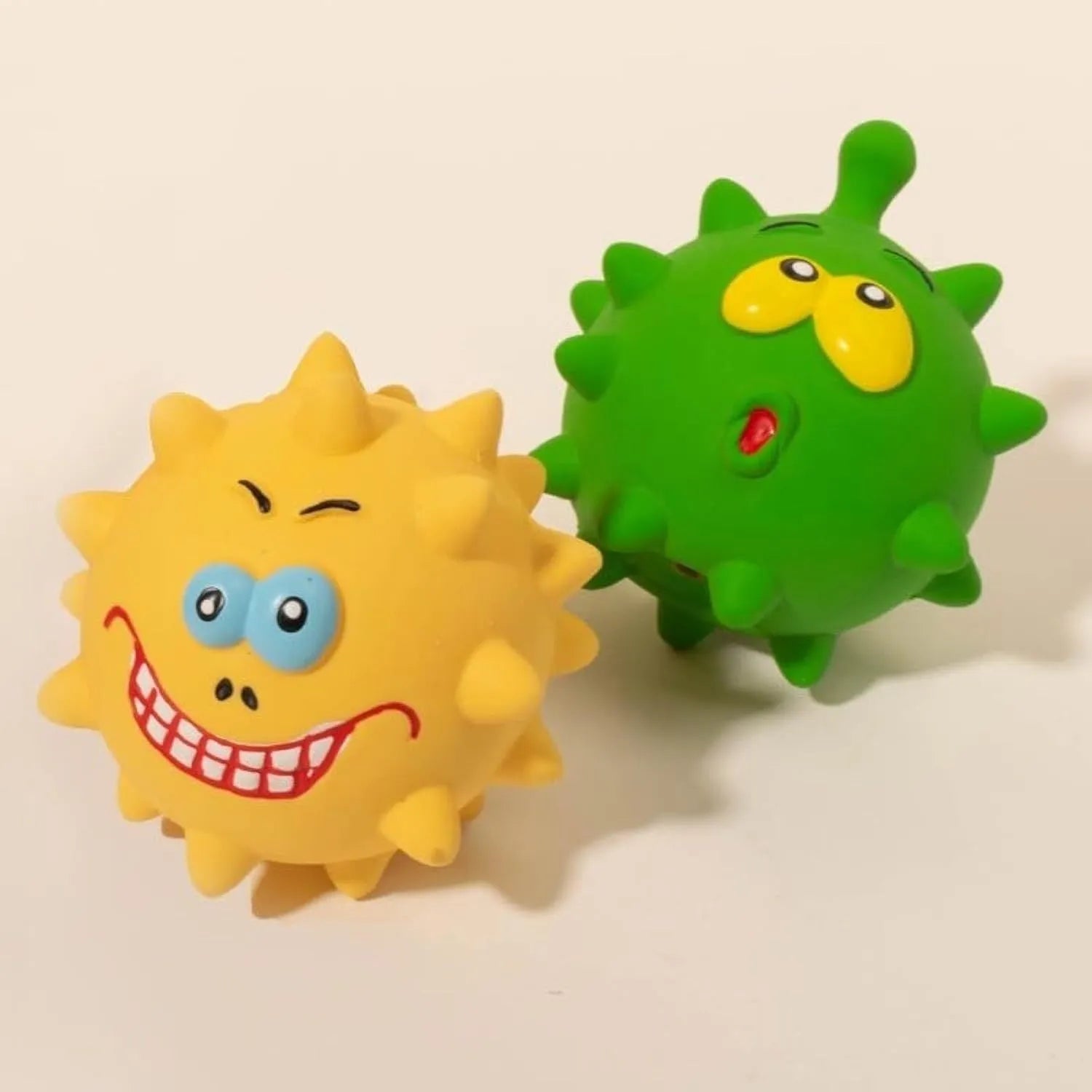 Colourful natural latex squeaky dog ball with cute face and textured surface for teeth cleaning.