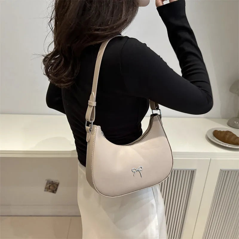 Women's dumpling-shaped shoulder baguette handbag in PU material with single strap and mobile phone compartment