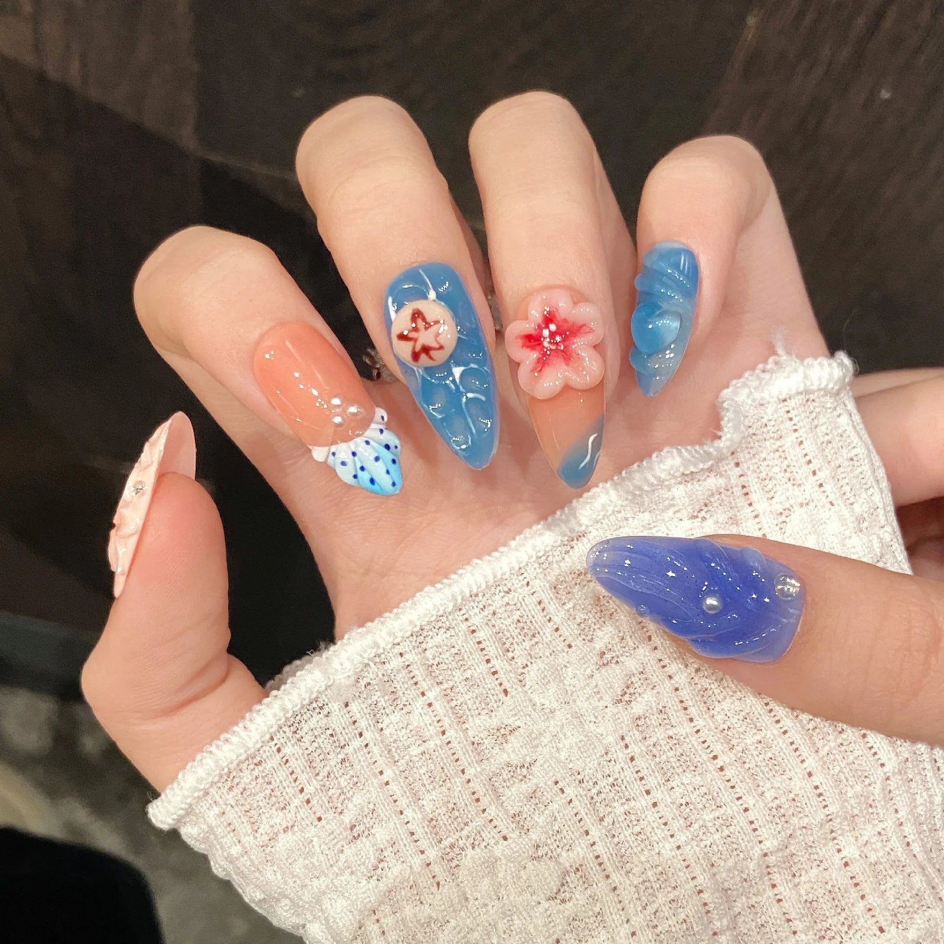 Three-dimensional carved jellyfish marine style plastic wearable armour in almond nail colour with rose, tulip, and XINGX patterns