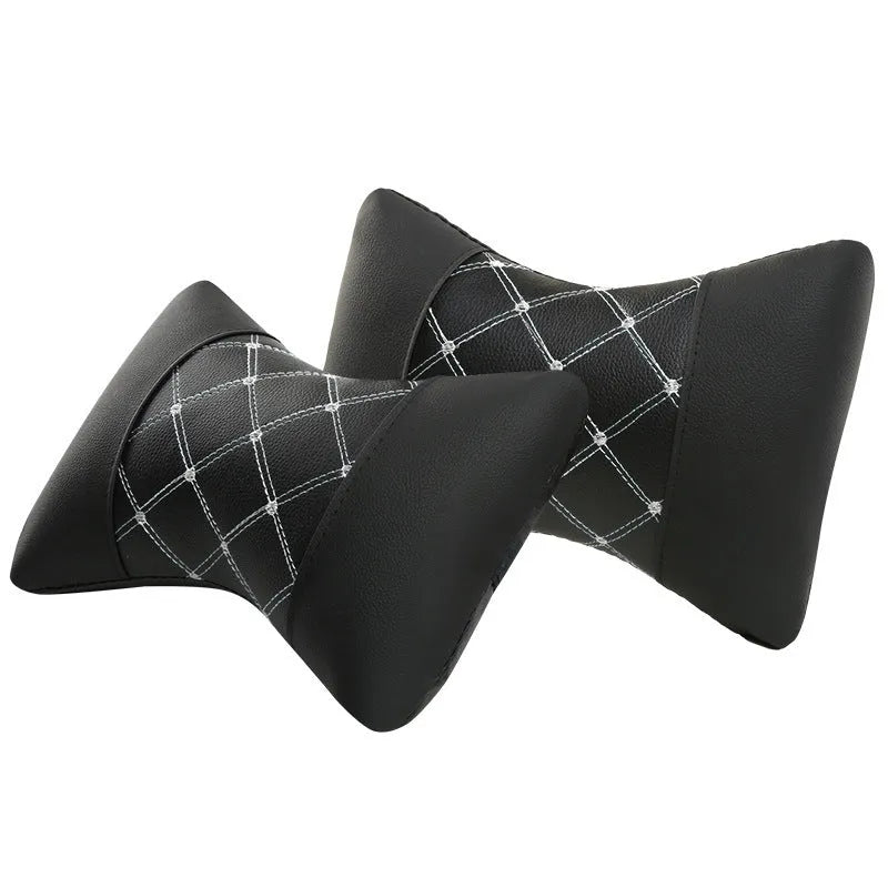 Black diamond quilted car headrest pillow with contrast stitching for neck support.