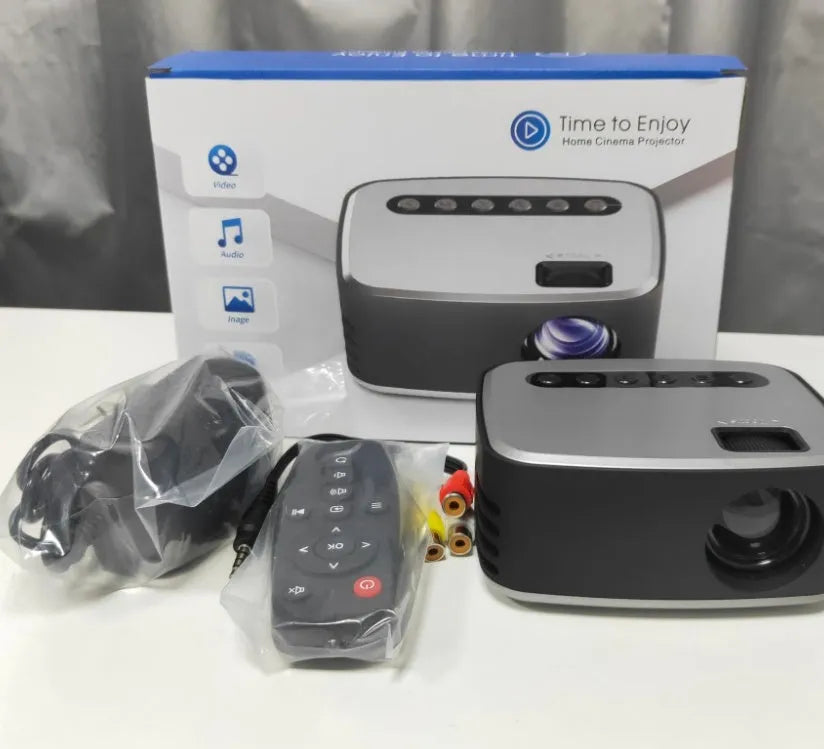 Mini LED projector in black with manual focus lens and multiple input ports on front panel
