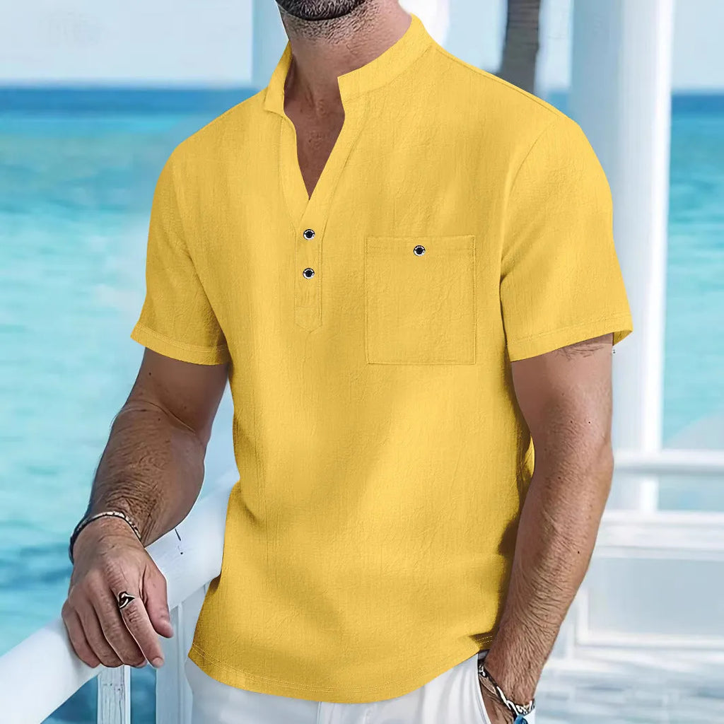 Man wearing a light-coloured linen blend stand collar t-shirt with short sleeves.