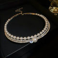 Silver curved geometric clavicle necklace for women on a white background.