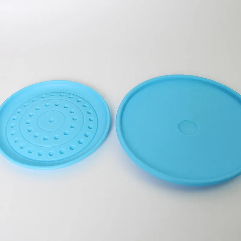Rubber dog frisbee toy in green colour, showing soft plastic construction suitable for throwing and catching games with pets