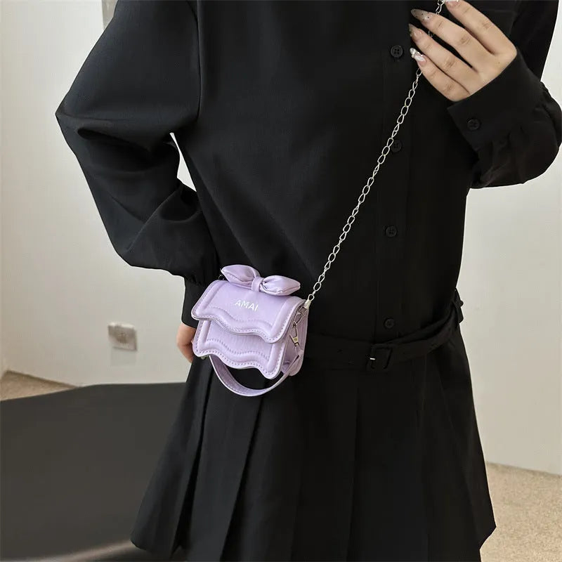 Women's small black PU leather crossbody bag with a single shoulder strap.