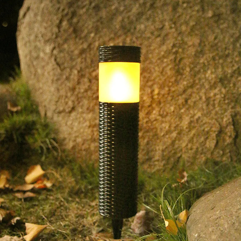 Solar-powered outdoor decorative garden light with abstract design and simulated flame effect