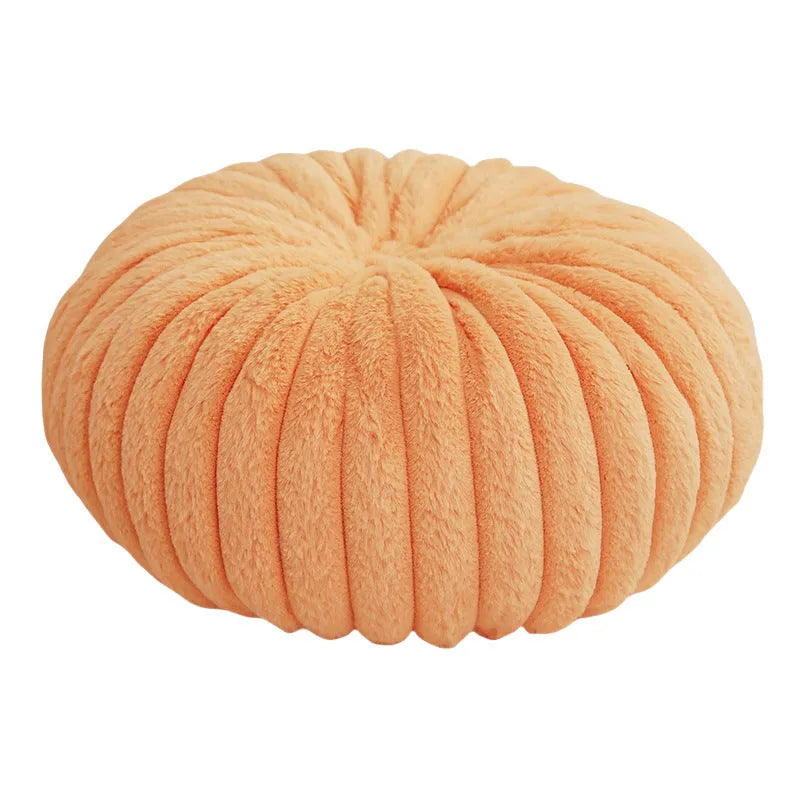 Pumpkin shaped seat cushion in khaki with short plush cover, 35x35x15cm, next to a window