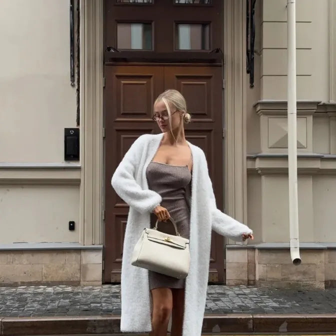 White thick-knit women's cardigan jacket with long sleeves, shown open as a loose-fitting layer.