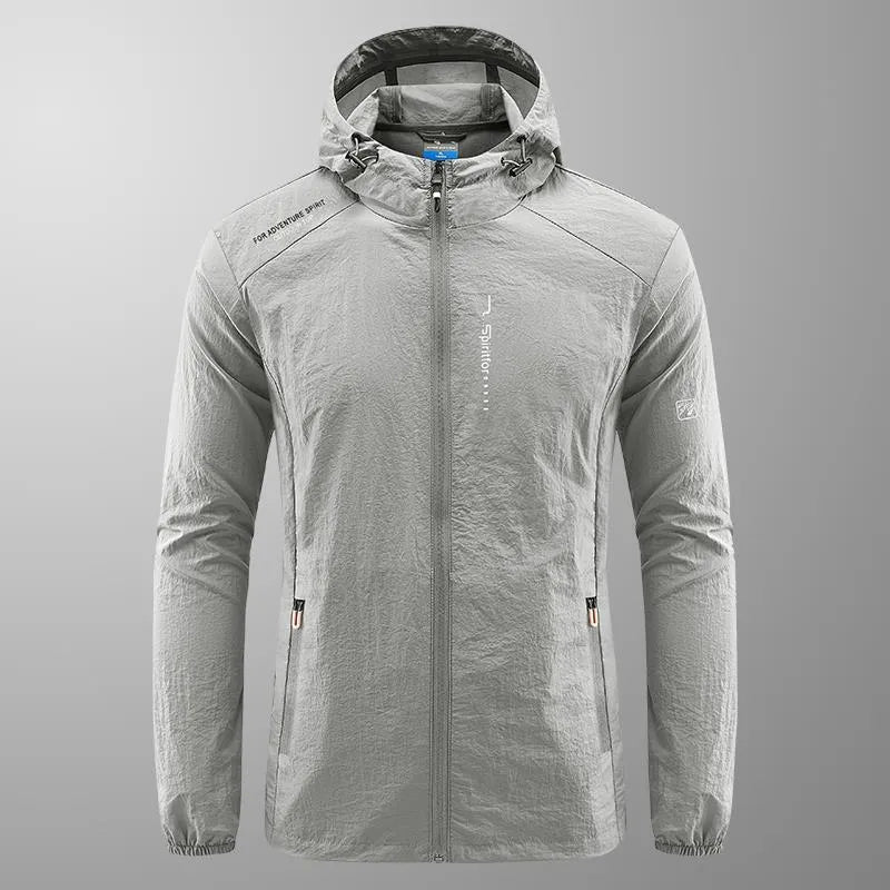 Man wearing a lightweight grey hooded nylon jacket for summer sun protection