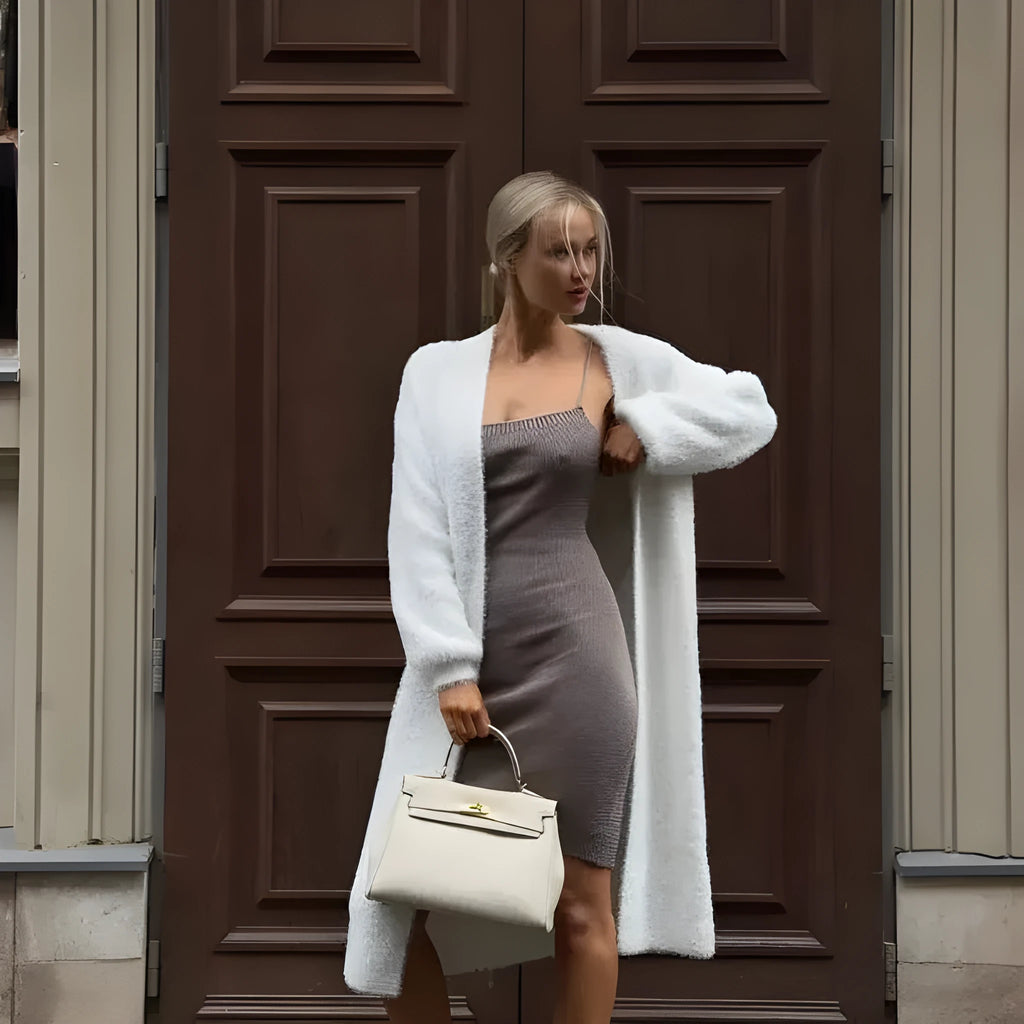 White thick-knit women's cardigan jacket with long sleeves, shown open as a loose-fitting layer.