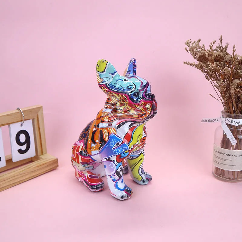 Modern simple French bulldog resin statue in graffiti colour finish on a plain background.
