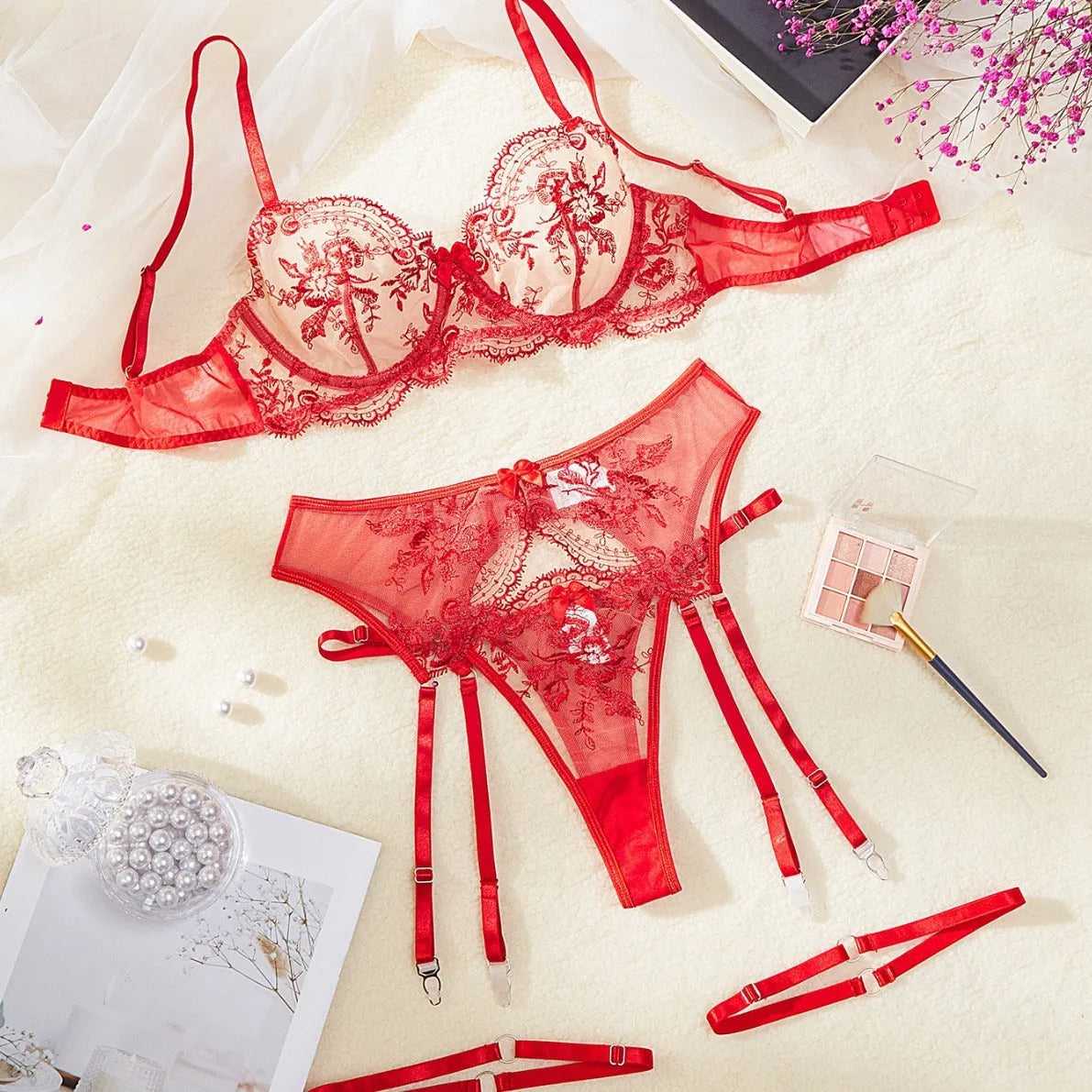 Women's sapphire blue see-through embroidery underwear set with cutouts, includes top, t-pants, and garters.