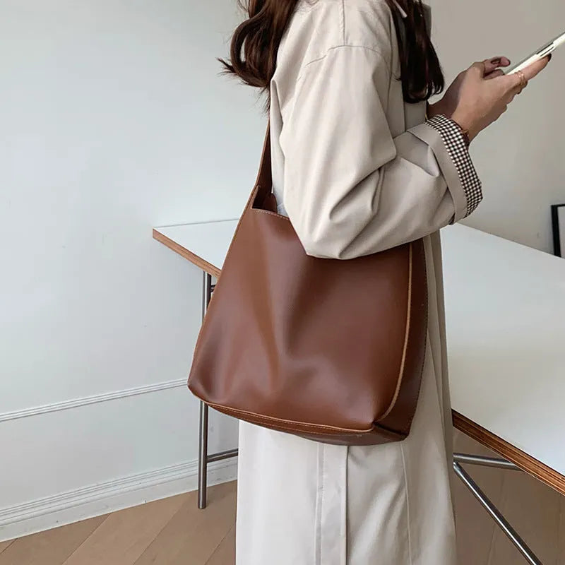 Women's solid colour PU leather shoulder bag in black, square vertical shape with sewing thread detail and single strap