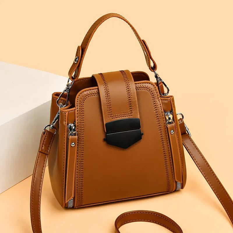 Soft black PU leather square vertical ladies handbag with textured stitching.