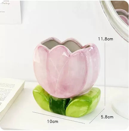 Ceramic tulip-shaped pen holder and storage box in a floral colour pattern on a desk.