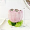 Ceramic tulip-shaped pen holder and storage box in a floral colour pattern on a desk.