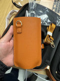 Brown leather battery power shoulder strap protective cover on a black strap, front view