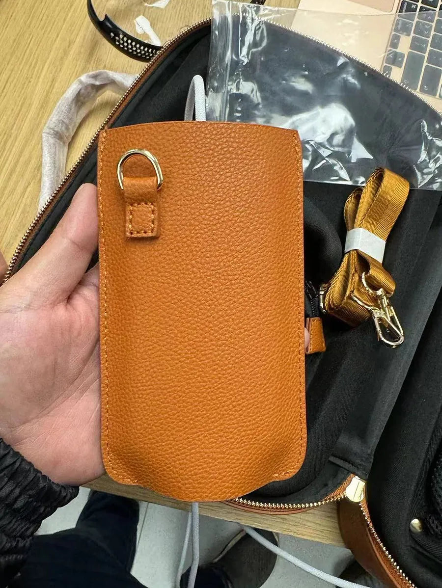 Brown leather battery power shoulder strap protective cover on a black strap, front view