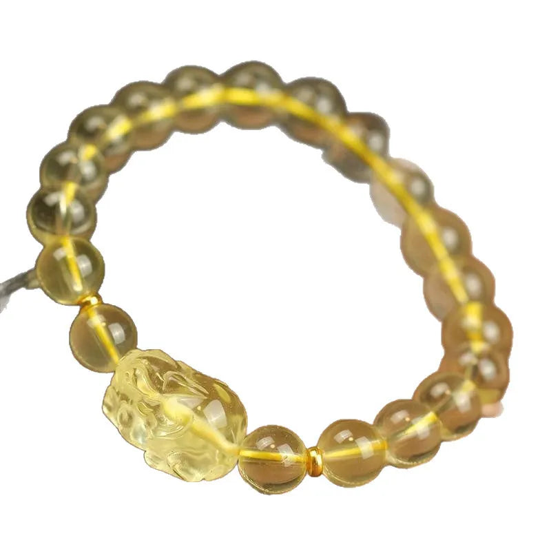 Yellow Pi Xiu bracelet with artificial crystal beads on an adjustable leather strap.