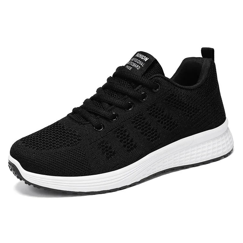 Women's black flyknit casual running shoes with white soft sole and flat heel on a grey background.