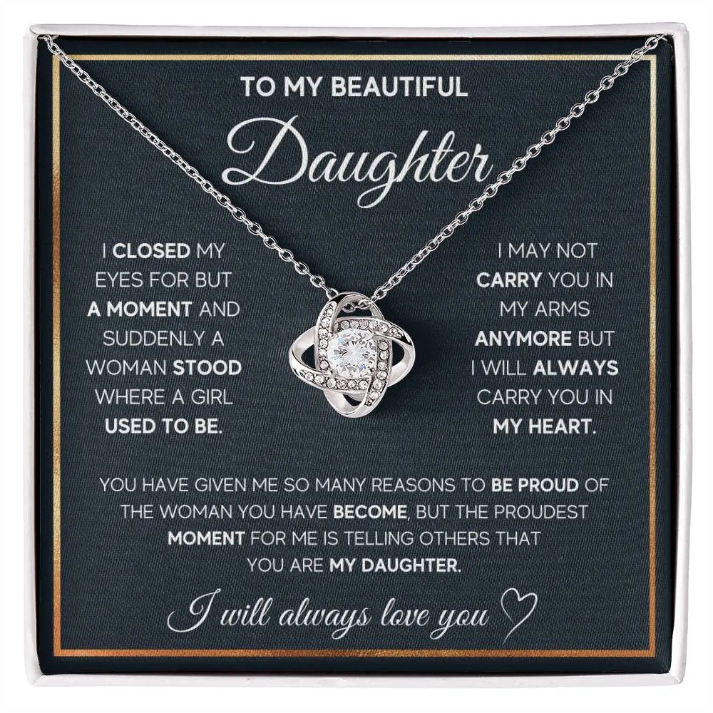 Silver metal four-leaf clover hollow jeweled pendant clavicle chain on display with geometric shape and card beside flip gift box