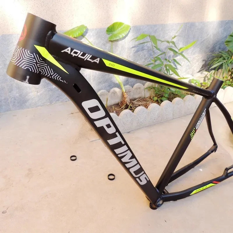 Black green 29 inch aluminium mountain bike frame showing internal cable routing ports and disc brake mount.