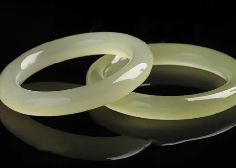 Polished ice-like silk jade round bar bracelet showing its geometric shape and smooth surface