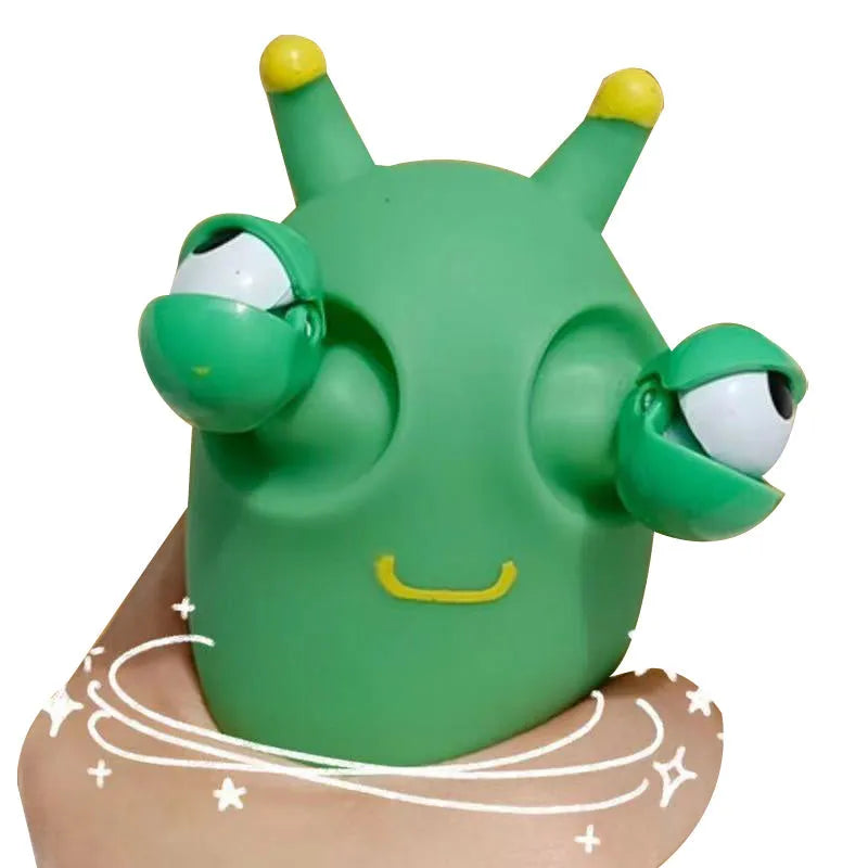 Green caterpillar squeaky toy with eye-popping feature, 8cm long PVC decomposition prank item