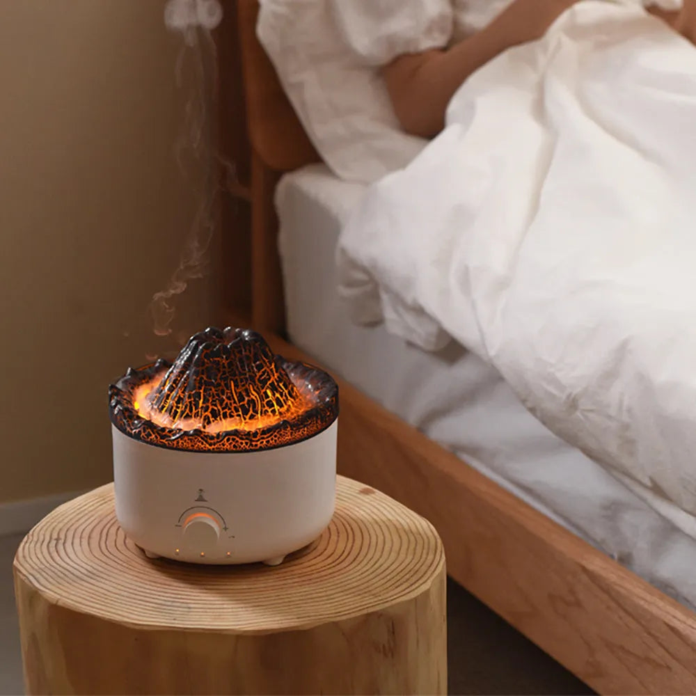 Small white volcano-shaped humidifier with simulated flame lighting and remote control