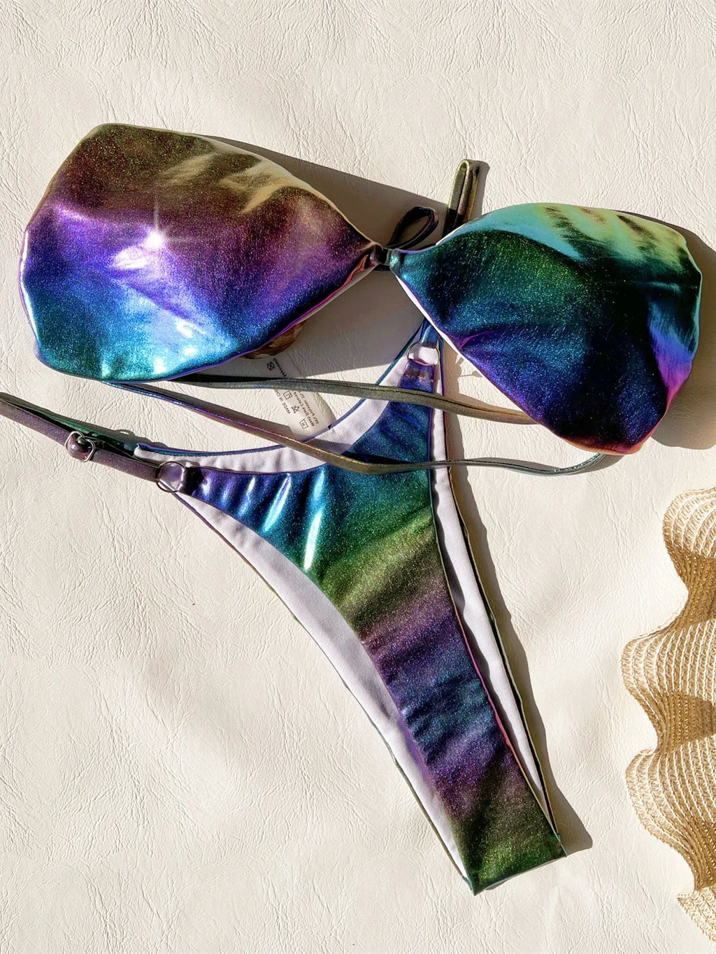 Women's gradient purple polyester bikini swimsuit laid flat, showing top and bottom.