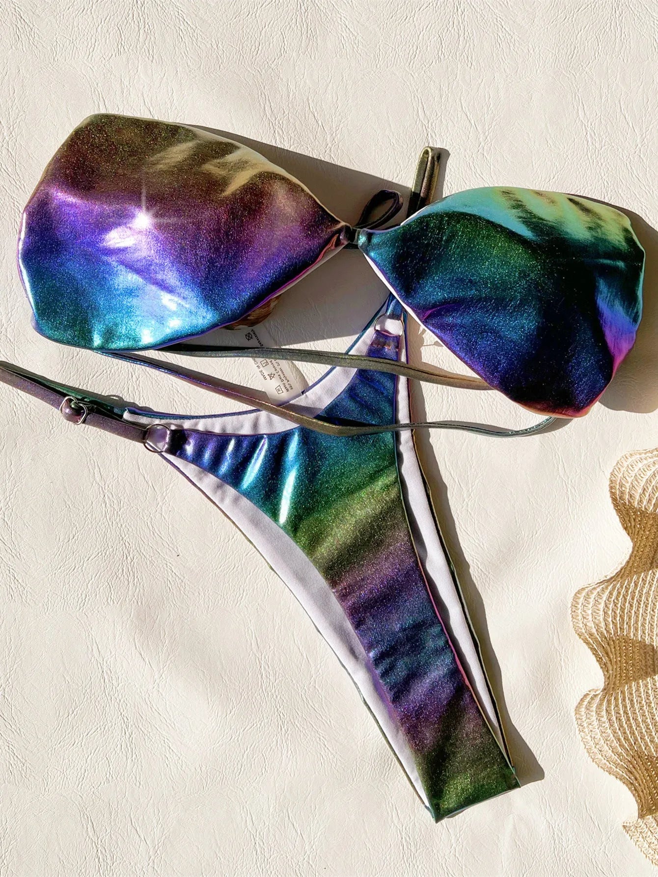 Women's gradient purple polyester bikini swimsuit laid flat, showing top and bottom.