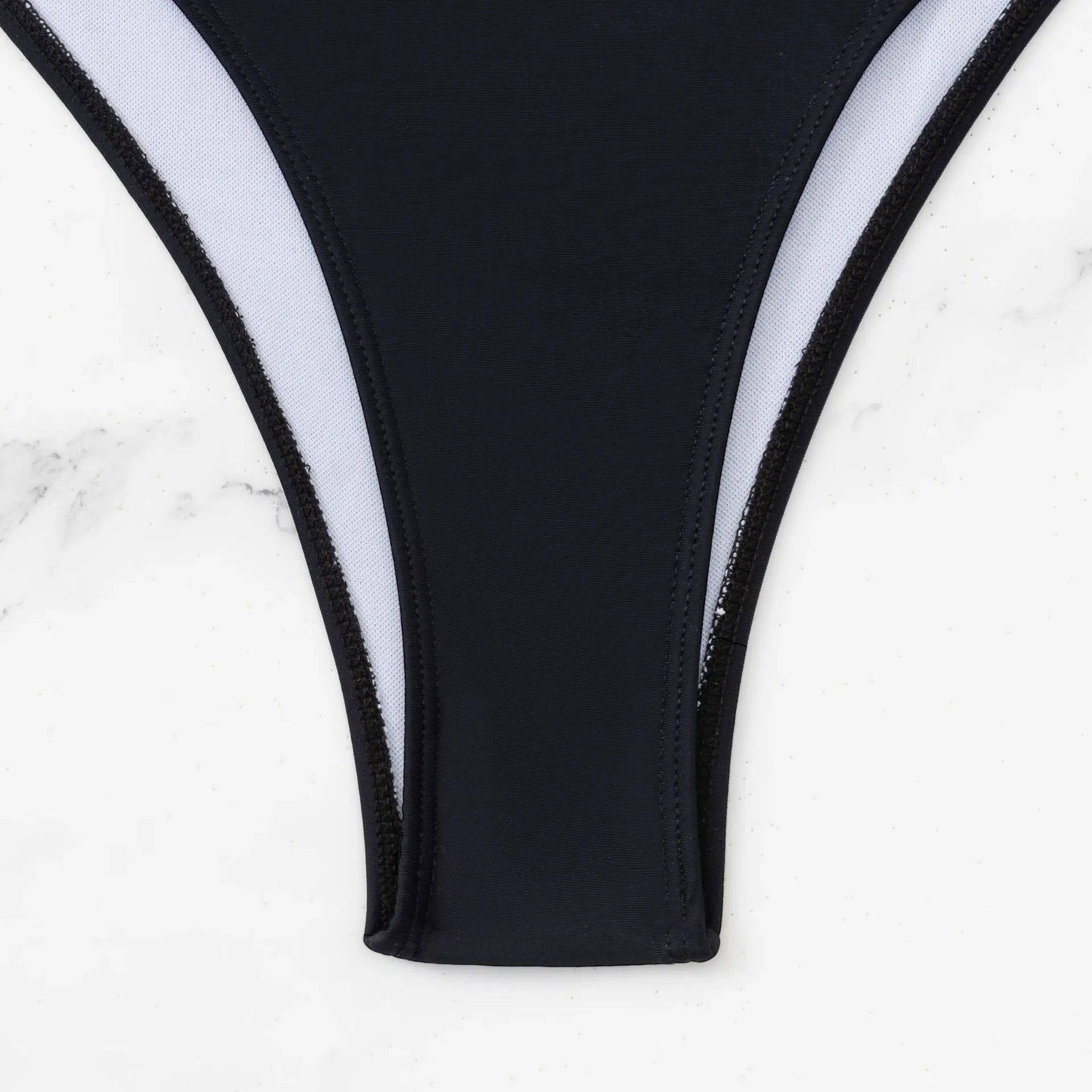 Black women's one-piece swimsuit with white contrast stitching and hollow back design