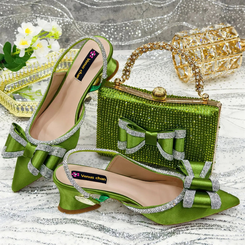 Women's black pointed toe sandals with elastic band and matching square rhinestone clutch bag on a neutral background.